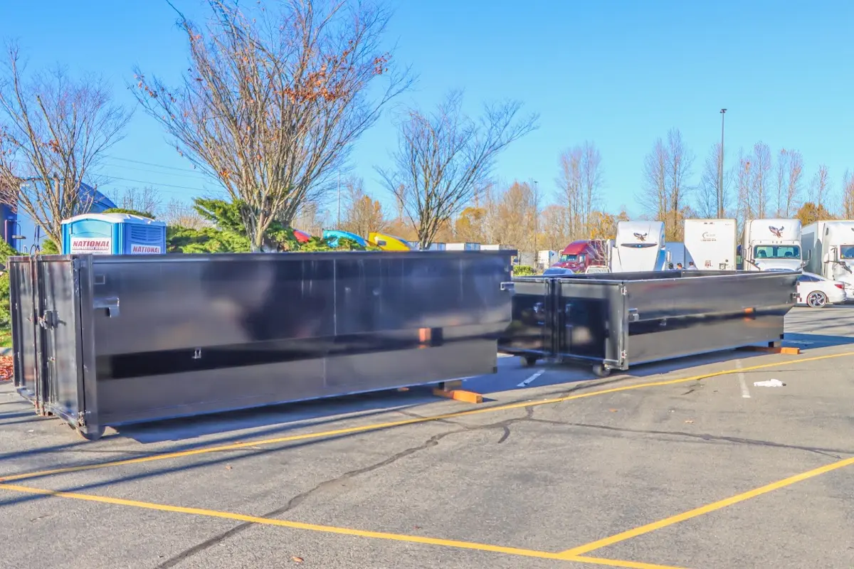 Professional dumpster rental service with roll-off container on residential driveway in Coral Springs